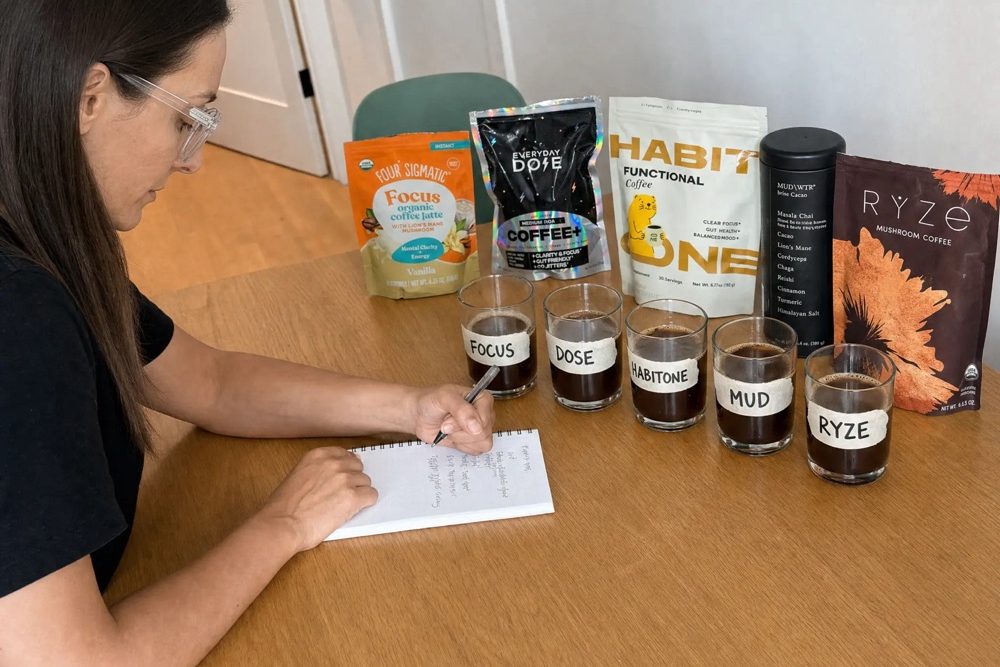 Melissa taking notes in front of five mushroom coffees and five labeled glasses